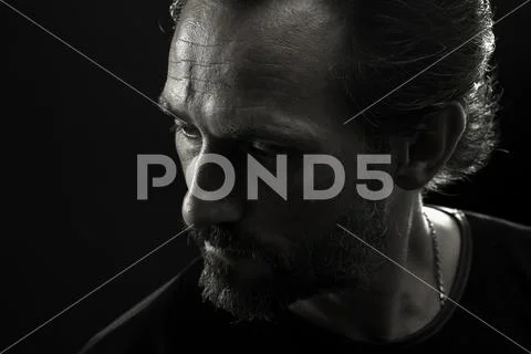 Monochrome portrait of strong man turnig face to left side. Stock-Fotos
