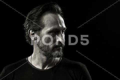 Monochrome portrait of wrinkled man with self-satisfied face. Stock Photos