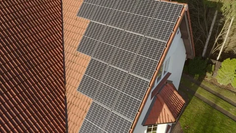 Monocrystalline solar panels made of solid silicon crystal on a tiled roof. Stock Footage 255320615