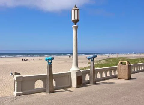 Monoculars and a light post overlooking the beach. Stock Photos