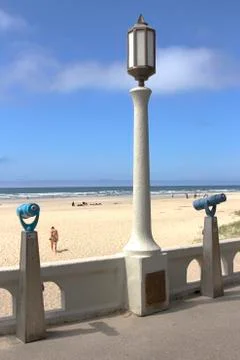 Monoculars and a light post overlooking the beach. Stock Photos