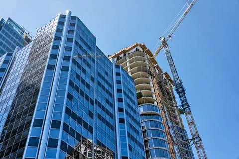 Monolite concrete building under constraction on blue sky background Stock Photos