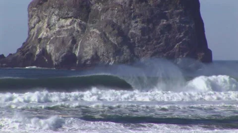 Monolithic rock with white water waves Stock Footage 60428854