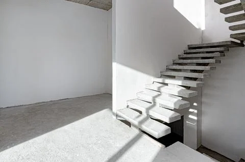 Monolithic staircase in a house under construction. Stock Photos