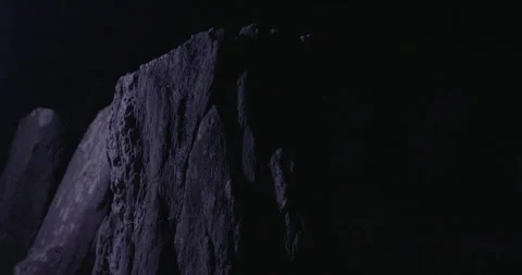 Monolithic stone looms in the darkness at Drombeg Circle, its surface etched Stockbeeldmateriaal 307617427