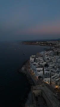Monopoli old town architecture lining the adriatic sea, with white buildings and Stock Photos
