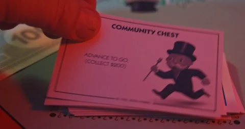 Monopoly board game. Player turns over Community Chest card. Stock Footage 122406966