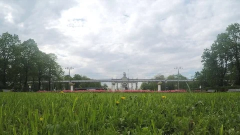 Monorail and flowerbed in front of arch timelapse Stock Footage 78016739