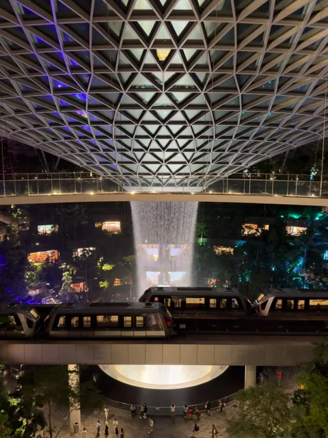 Monorail Passing Rain Vortex Waterfall at Jewel Changi Airport, Singapore Stock Footage 312611054