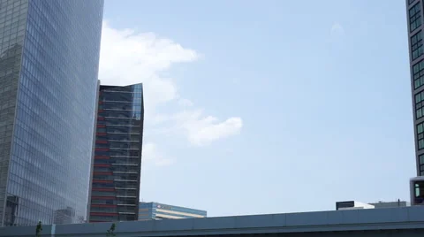 Monorail running between the skyscrapers Stock Footage 66654647