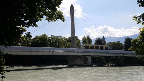 Monorail train goes over the river called Inn. Stock Footage 91630729