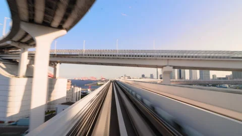 Monorail train travel between stop in Odaiba, Tokyo during sunrise. Stock Footage 196476241