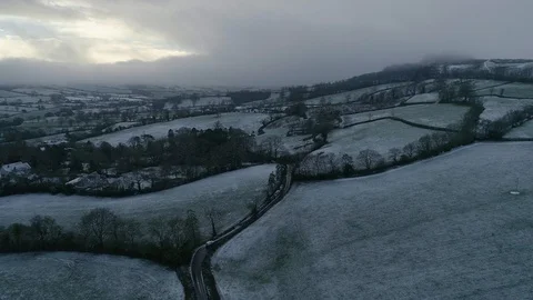 Monotone looking drone shot of a wintry snowy scene in east Devon farmland Stock Footage 102877024