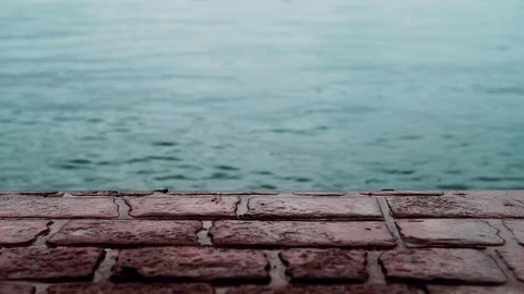 Monotone Red Brick Stone Pavement Pier Beside Blue Sea Stock Footage 88837754