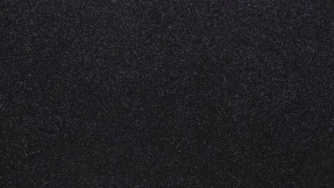 A monotonous black background in fine grain and a flashing light beam of light Stock Footage 232747820