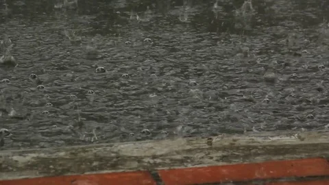 Monsoon drops on patio Close Up &amp; wider view Stock Footage 74419910