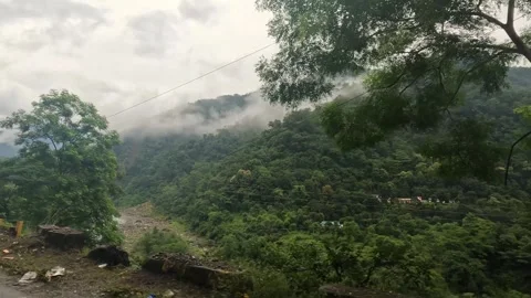 Monsoon mist and low clouds drifting over the mountain valley highway near .. Stock Footage 337768321