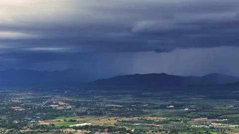 Monsoon stormfront covers valley with dense rain in tropical climate during wet Stock Footage 315225248