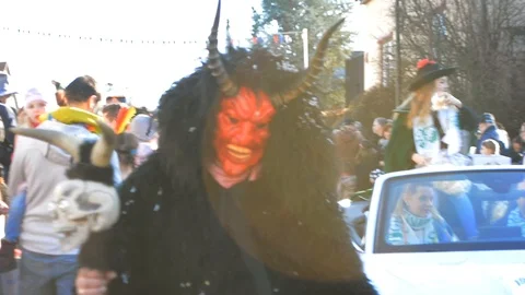 Monster devil mascot posing at dark carnival of South Germany, medium shot Stock Footage 105738008