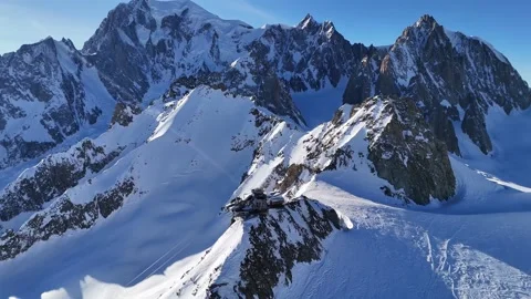 Mont blanc cable car station perched on snowy mountain ridge aerial view Stock Footage 340871370