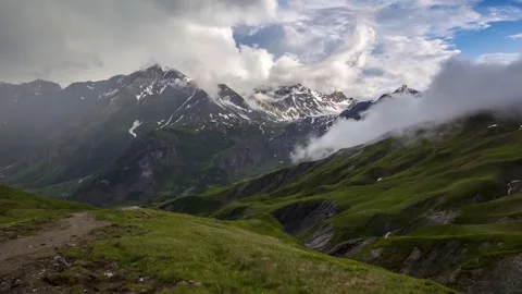 Mont blanc mountain range snowy peak cloud roll over green alpine valley Stock Footage 340862302