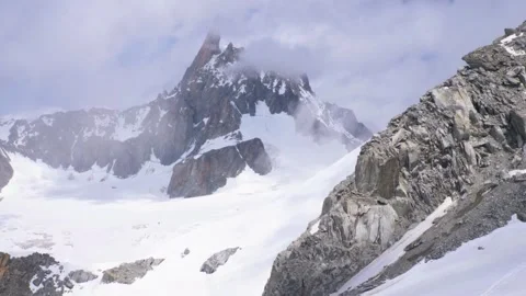 Mont blanc rocky peak sharp spire cloud mist drift over high alpine Stock Footage 340869247