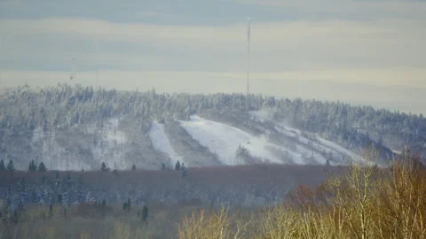 Mont-Comi Ski hill resort slopes winter distant view with antenna transmission Stockbeeldmateriaal 256994580