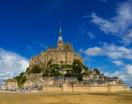 Mont Saint-Michel in Normandy, France under blue skies Stock Photos