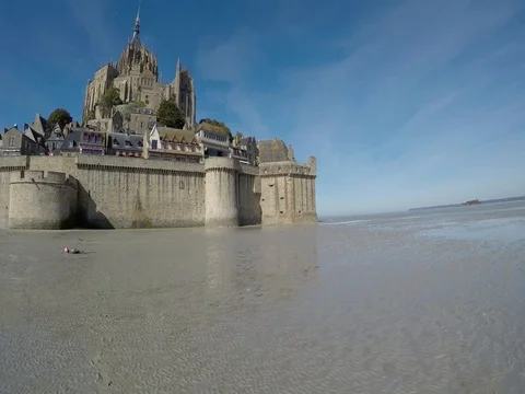 Mont St. Michel - Pivot from mudflats to island Stock Footage 80365651