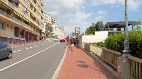 MONTE CARLO, MONACO - AUGUST 18, 2024: People walk, cars pass on street Stock Footage 316613437