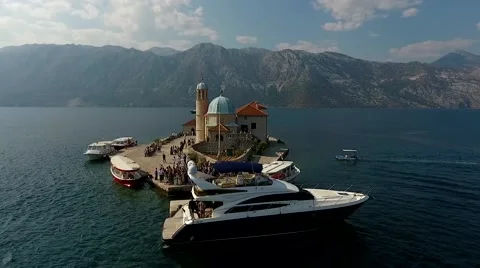Montenegro, bay air shooting (tiny island with people and many yacht Stock Footage 68116738