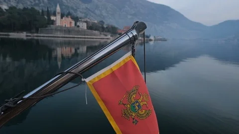Montenegro flag develops in the wind against the background of the yacht 스톡 동영상 124337607