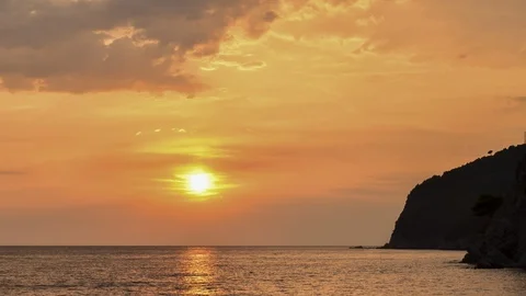 Montenegro. Orange sunset sky with reflection on sea. Slowly clouds. Stock Footage 128679613