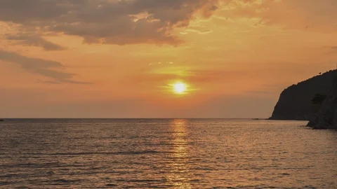 Montenegro. Orange sunset sky with reflection on sea. Slowly clouds. Stock Footage 128679624