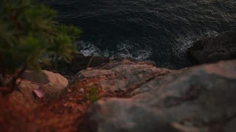 Montenegro's rugged limestone cliffs frame the dark Adriatic as waves break into Stock Footage 329411998