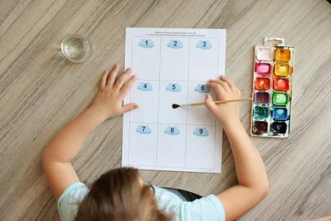 Montessori material. Children's hands. The study of mathematics and seasons.  Stock Photos