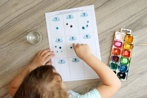 Montessori material. Children's hands. The study of mathematics and seasons.  Stock Photos