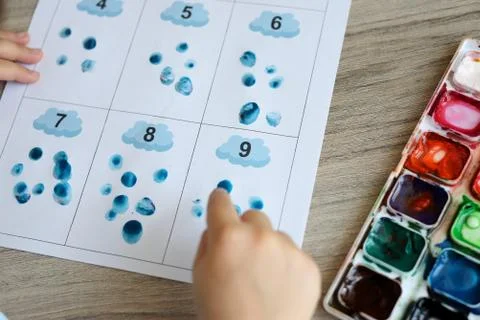 Montessori material. Children's hands. The study of mathematics and seasons.  Stock-Fotos