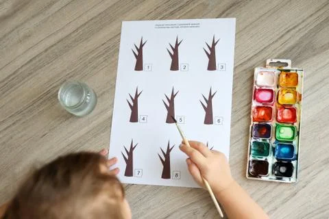 Montessori material. Children's hands. The study of mathematics and seasons.  Stock Photos