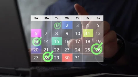 Monthly work schedule with green check marks on selected dates, planning and Stock Footage 315585310