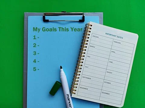 Monthly workbook, marker work notes my goals this year green background Stock Photos