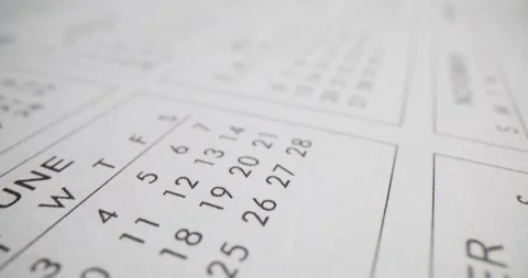 Months and dates printed on white calendar page in office Stock Footage 269116483