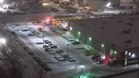 Montréal, Canada Dec '25 - Emergency vehicles resting in a snow-covered depot Stock Footage 324868704