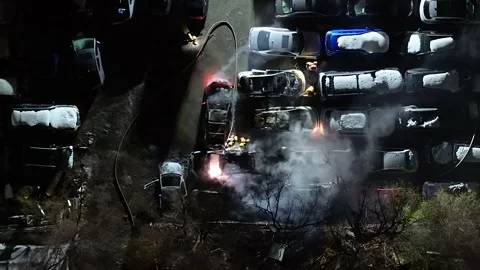 Montréal, Canada Dec 3 '25 - Overhead Crews Douse Burning Vehicles At Night Stock Footage 325539573
