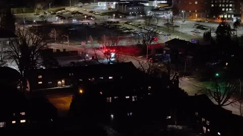 Montréal, Canada Nov '25 - Aerial follow shot of ambulance racing through urban Stock Footage 324856460