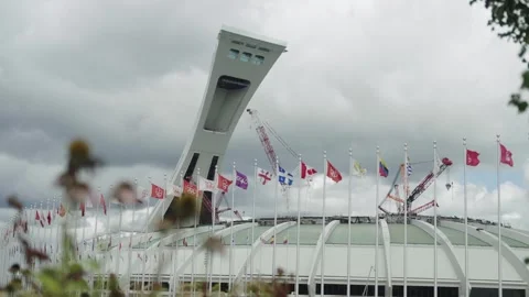 The Montreal Olympic Stadium Tower Behind Waving Flags, Canada Vidéo 336947657