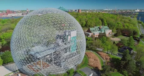 Montreal's Biosphere dome rises above lush green trees. Montreal, CA Stock Footage 314776653