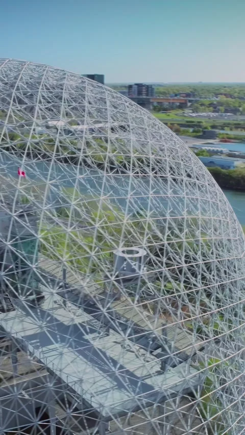 Montreal's Biosphere dome rises above lush green trees. Montreal, CA Stock Footage 315076053