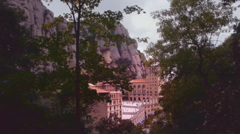 Montserrat monastery behind trees  cloudy sky Video stock 32182413
