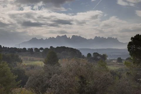 Montserrat mountain range appearing through atmospheric haze Stock Photos